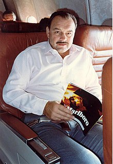 Dick Butkus sitting and holding a Marlboro magazine.
