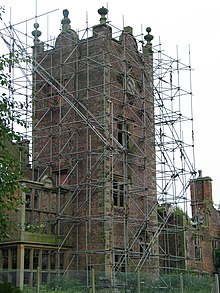 A view of the clock tower covered in scaffolding