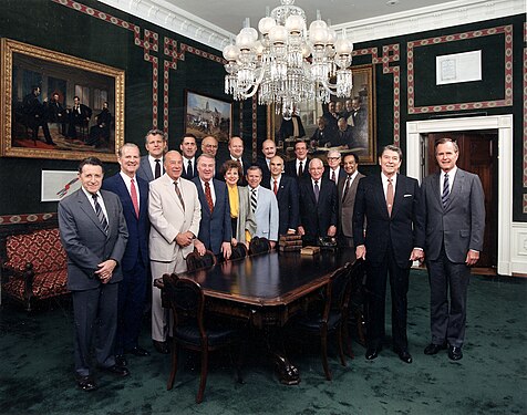 Photo of Ronald Reagan and his Cabinet in the Treaty Room where the painting used to hang, before it was moved to the Oval Office Dining Room. The painting is visible behind Reagan's Cabinet on the far left