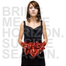 A girl in a black dress looks on at the camera with a blank expression, while holding her intestines above her waist.