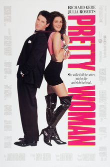 A man in a smart black suit stands back to back with a woman wearing a black short skirt and black thigh-high boots.