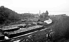 Image of the Angeles brewery, some time between 1901 and 1915. A large stack of cordwood is near the structure.