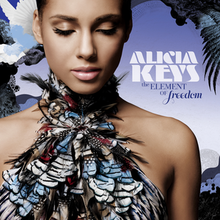 A woman with her eyes closed, wearing a feathered dress that covers her chest, bares her shoulders and goes around her neck. Laid against a blue background, a white dove is seen flying behind her to the left. The name "Alicia Keys" is written to the right in white font and "The Element of Freedom" is written below that in dark blue font.