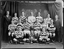 Portrait of New Plymouth football team with the Chinese Residents Challenge Cup in 1926