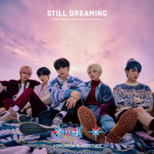 The cover is a square picture of the members sitting down, with a cloudy sky background filled with pink and purple hues. The title "Still Dreaming" is written in all caps, white bold font at the upper center. Below the title is the members' name in order Soobin, Yeonjun, Beomgyu, Taehyun and Hueningkai. The promotional logo of the band appears at the bottom center.