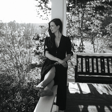 Joy Williams on the front porch of a house in the country
