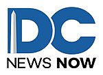 Large, thick blue letters DC, with the D sitting atop the C, and the words "NEWS NOW" in black. On the left side of the letter D is a representation of the Washington Monument.