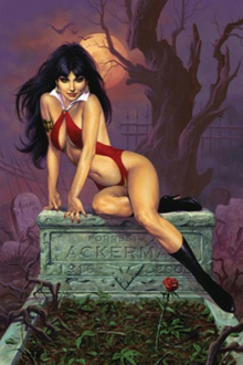 Vampirella reclining. She has dark black hair, red lips, and is wearing her red sling suit costume and black high heel boots