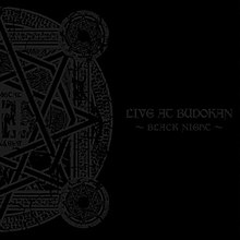 A black album cover, with one half of a circular design on the left side and the words "LIVE AT BUDOKAN" and "~BLACK NIGHT~" on the right side, both in a lighter black color.