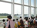 The viewing gallery of Singapore Youth Flying Club overlooking the runway of Seletar. Note the club's Piper Warrior taxiing on the runway.
