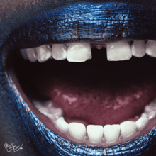 A closeup photo of an open mouth with lips painted blue.