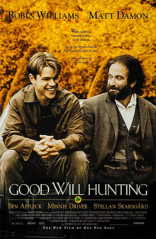 Matt Damon and Robin Williams sitting together on a bench, the background if full of yellowed leaves.