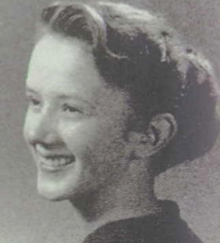 A smiling young white woman, hair in a ponytail