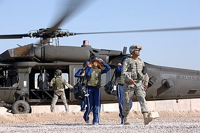Dallas Cowboys Cheerleaders disembarking a HH-60 Pave Hawk after landing in Iraq.