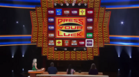 A screen shot of Press Your Luck, showing the game's board and contestant podiums