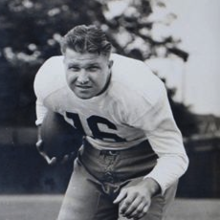 Terlep carrying a football in a white uniform