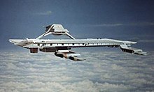 An airborne structure resembling a seagoing aircraft carrier, hovering at high altitude above clouds