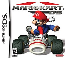Video game box art. A video game character, Mario, leaps over a racing cart.