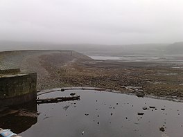 Image of an almost dry reservoir in heavy mist