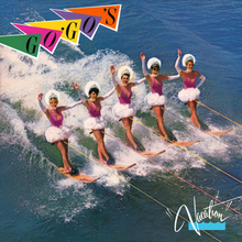 Five women water-skiing in formation, wearing pink swimsuits and white tutus