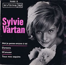 Black and white photograph of French pop singer Sylvie Vartan holding a white cat