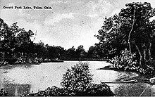 black-and-white image of a lake surrounded by trees