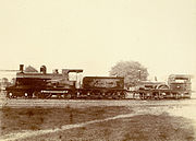 Photograph (1897) of the first locomotive, shown on the right and christened "multum in parvo" (barely visible on the wheel casing), which was used by the East Indian Railway Company in 1854 on its 23-mile line from Howrah to Pandua.