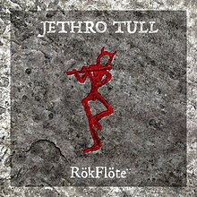 A red stick figure with horns playing a flute against a stone-grey background, with the artist name and album title printed in white above and below the figure