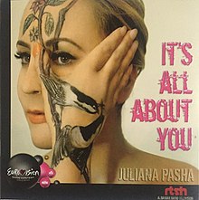 The cover portrays Juliana Pasha's face and her hand on her face, with tattoos on her wrist and face