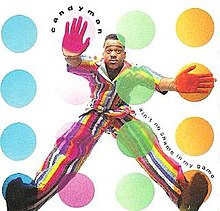 A man wearing a multi-colored striped suit has four colored circles in front of him: blue, magenta, green and orange. He has his left hand and foot on a magenta and blue circle respectively, and has his right hand and foot on the orange circles.