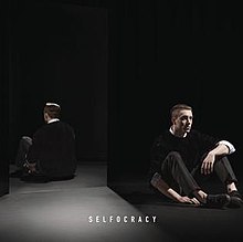 Nottet laying on the ground in front of a mirror, with his reflection being visible.