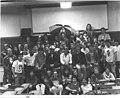 The Spring 1987 KMNR station photo in the old Mining Building. First row: Cindy Walk, Jennifer Jones, Brent Jones, Vito Biundo (Ex-Station Manager), ?, Gene Hoeltge, ?, Steve Hendren, George Carini (Dr. Sunshine Show), ?, ?. Second Row: Monster #?, ?, Bryan Adams, Jeff Brown, Jennifer Sommers, Jim Column, ?, ?, ?, ?. Third Row: Bald Dude, Kathy Dolsen (Former Personnel Director, Station Manager), ?, ?, Bob Linke, ?, James Haring, ?, ?, ?. Fourth Row: Scott Birdsong, Jeff Leith and Alletta Curtis (married), Eric Bussen, Dave Meriwether, ?, Mike Harvey (Ex-Station Manager), Rick Karbowski, ?, ?, ?, ?. Top Row: Doug Moyer, Kid with Had, ?, ?, Guy with Umbrella, Dean McDowell, Don Grahler, Greg Boice, Jim Calzone, Joe Heberlie, ?.