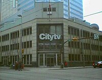 A view of a building at a street corner with Citytv signage.