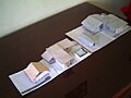 Paper architectural models of a bungalow, office and house.