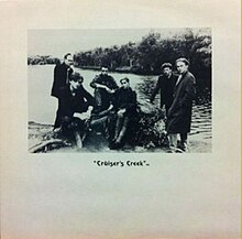 Black-and-white single cover, with photograph of six-piece band posed along a riverside above the words "'Cruiser's Creek' PG"